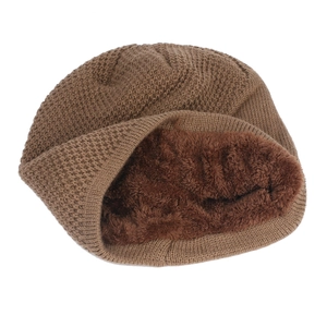 Detail of winter beanie showing brown waffle knit exterior and thick faux fur fleece lining