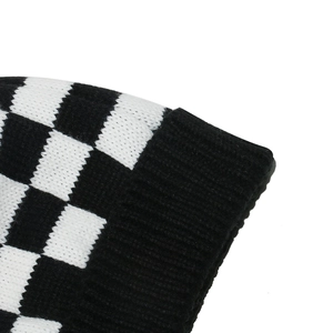 Close-up of checkered knit beanie featuring thick texture and ribbed black cuff detail