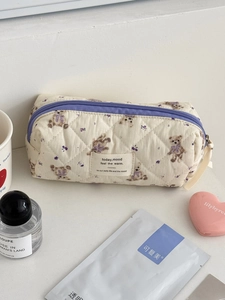Quilted cotton cosmetic bag with purple bear pattern in a cozy lifestyle setting