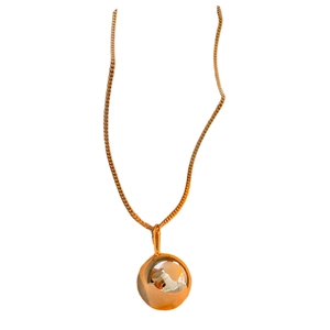 Minimalist gold ball pendant necklace in stainless steel with a polished mirror finish