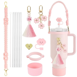 Pink water bottle accessory set with woven lanyard, straw covers, and silicone boot