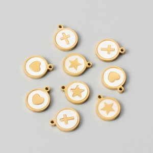 Flat lay of gold stainless steel shell pendants with heart star and cross patterns
