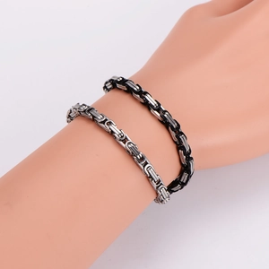 Silver and black Byzantine stainless steel bracelet with magnetic clasp on a wrist