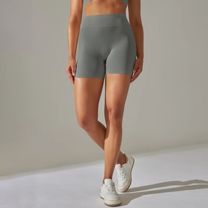 Detail view of high-waist seamless ribbed yoga shorts in grey showing peach butt lift effect