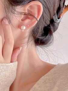 Elegant 925 sterling silver pearl stud earrings with zircon shown on a model