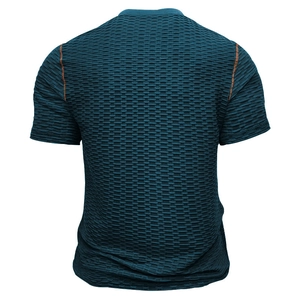 Détail du tissu en maille bleu sarcelle foncé avec surpiqûres orange contrastées