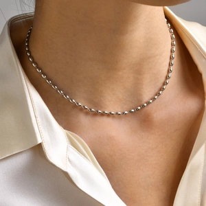 Silver olive bead necklace on neck, minimalist stainless steel beaded choker for women