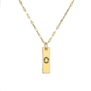 Macro shot of gold-plated rectangular pendant with colorful rhinestones in letter O shape