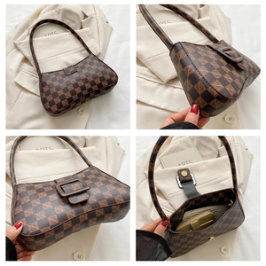 Brown checkered shoulder bag with decorative buckle and spacious internal capacity