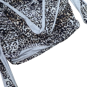 Detail of leopard print fabric with textured ruching and durable hemmed edges