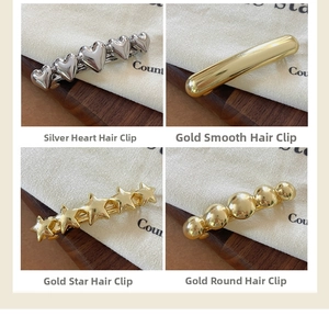 Detail view of four metal spring hair clips in heart, star, and geometric shapes