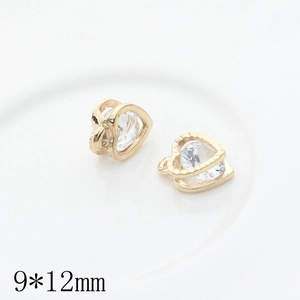 Detailed macro view of 9x12mm golden heart-shaped charms with zircon inlay for jewelry