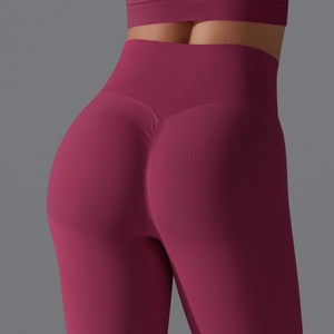 Detailed back view of high-waisted seamless scrunch butt yoga leggings in dark burgundy
