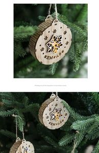 Close-up of laser-cut wooden Christmas ornaments with snowflake patterns and gold accents