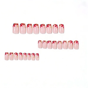 Short square press-on nails with pink base, red floral patterns and gold foil flakes