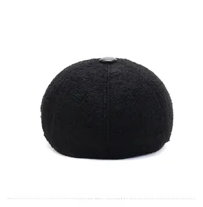 Detail view of the black fleece textured crown and center button on the winter ivy cap