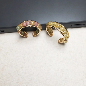 Detail of handmade 14K gold-filled wire wrapped ear cuffs with natural crystal beads