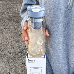 Minimalist portable water bottle with tea infuser and light blue leak-proof lid with handle