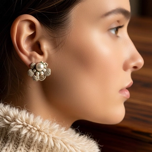 Elegant close-up of vintage flower-shaped pearl stud earrings with crystal details on a model