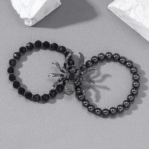 Detail of gothic spider charm bracelet set with black beads and dark rhinestones