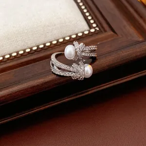 Lustrous pearl knotted open ring with shimmering zircon stones in a silver finish