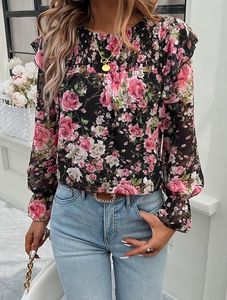 Close-up of floral print chiffon blouse with delicate smocked details and ruffled collar trim