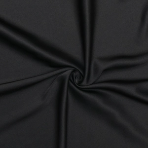 Detail of smooth black polyester fabric with elegant silky texture and drape