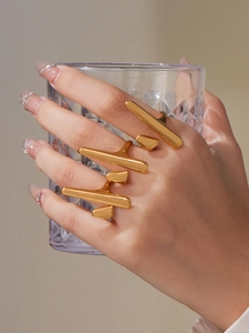 Detailed close-up of chunky gold-plated stainless steel geometric rings set for women