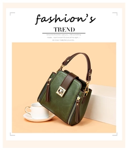 Detail of vintage green bucket bag featuring a gold square buckle and side zipper accents