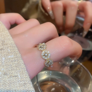 Detail of 14k gold plated ring featuring three sparkling starburst zircons on band