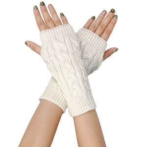 Detailed knit texture of cable pattern fingerless gloves in cream white acrylic