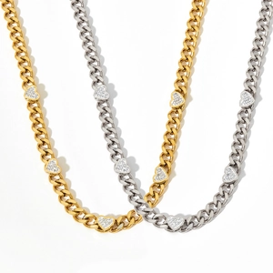 Gold and silver Cuban chain necklaces with heart-shaped zircon pendants on white background
