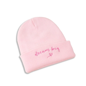 Detail of pink knit hat with Dream Big text embroidery and heart pattern stitching