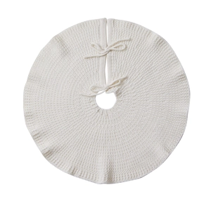 Creamy white knitted mini Christmas tree skirt with elegant bow ties on a white background