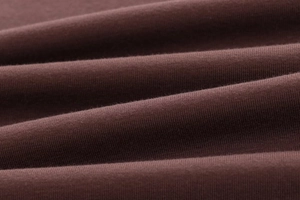 Close-up of high-quality dark brown modal fabric showing fine knitting texture and soft feel