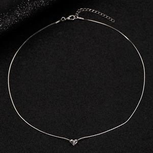 Detail view of heart pendant necklace with lobster clasp closure and extension chain