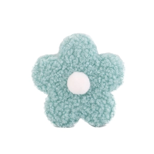 Detailed view of mint green teddy fleece flower accessory with soft lambskin texture