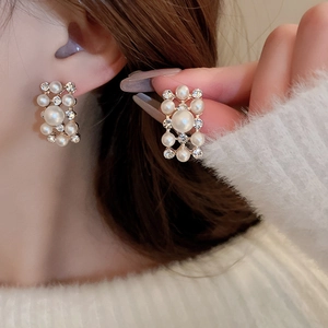 Vintage gold pearl and rhinestone earrings set shown on a model with close-up detail