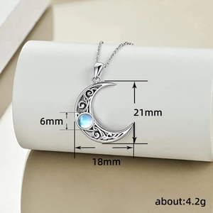 Silver crescent moon necklace with moonstone and filigree detail, 21mm by 18mm pendant