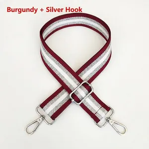 Close-up of adjustable 3.8cm nylon bag strap in burgundy with silver glitter stripes