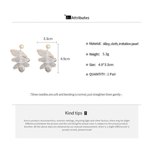 Detailed view of handmade lace flower earrings with faux pearls and size dimensions