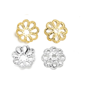 Macro view of gold and silver hollow flower beads for DIY jewelry making