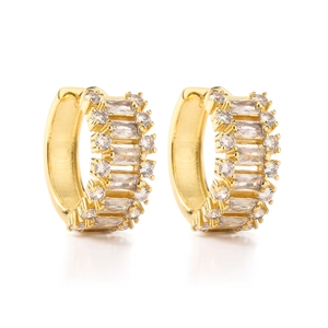 Macro detail of gold plated hoop earrings with baguette and round cut zircon stones