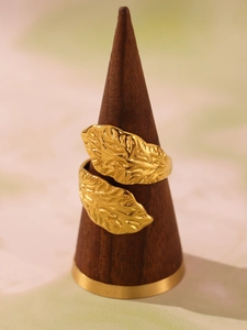 Macro detail of 18k gold plated stainless steel leaf ring with intricate vein textures