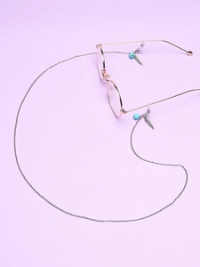Detail of stainless steel glasses chain featuring leaf pendant and turquoise beads