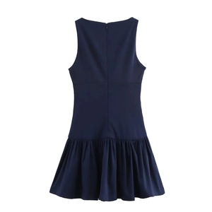 Close-up of sleeveless navy blue dress featuring pleated hem and hidden back zipper