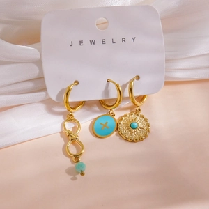Detail of 14K gold plated earrings set with natural stones and shell charms on display