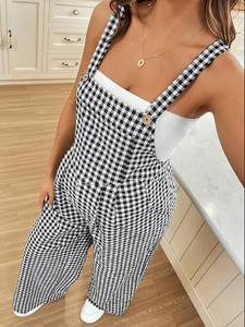 Relaxed black and white plaid maternity jumpsuit for women in a cozy home setting