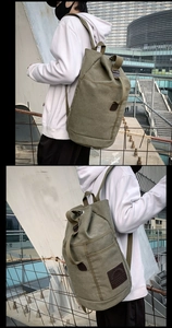 Macro detail of the durable olive green canvas texture and leather logo on the backpack
