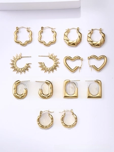 Detailed set of seven unique 18K gold plated titanium steel hoop and stud earrings